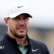 Brooks Koepka looks towards a green
