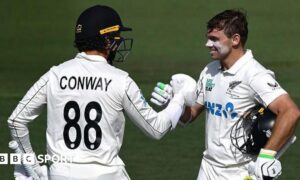 Dean Conway (left) congratulates Tom Latham on his century