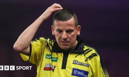 Dave Chisnall looks on