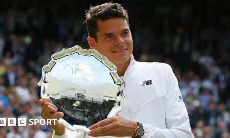 Milos Raonic hols the 2016 Wimbledon runners-up plate
