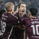 Hearts midfielder Tomas Magnusson (centre) is mobbed by teammates