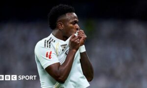 Vinicius Jr kisses the badge on his Real Madrid shirt