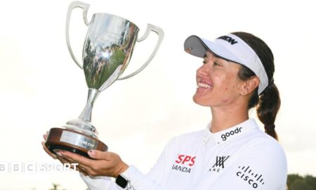 Hannah Green lifting a trophy