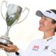 Hannah Green lifting a trophy