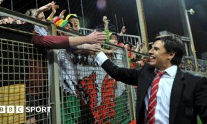 Chris Coleman celebrates with Wales fans after qualifying for Euro 2016 following the 2-0 loss in Bosnia-Herzegovina in 2015
