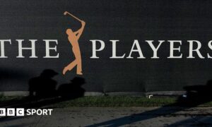 A sign at the Players Championship showing a silhouette of a person swinging a golf club between the words 'The' and 'Players'