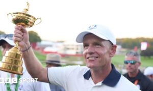 Luke Donald holds aloft the Ryder Cup trophy at Bethpage Black in 2025