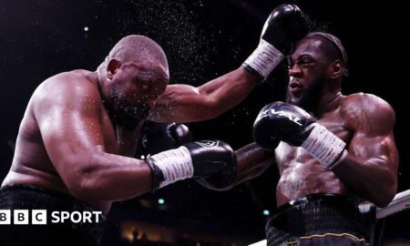 Derek Chisora is punched by Deontay Wilder