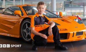 Harry Williams, McLaren's latest Driver Development Programme recruit, in front of a McLaren car.