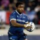 Nathan Jibulu running with the ball to his left side grasped in both hands during a match for Sale