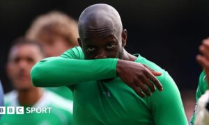Yoane Wissa wipes his nose on his arm