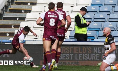 Adam Clune of Huddersfield scores a try