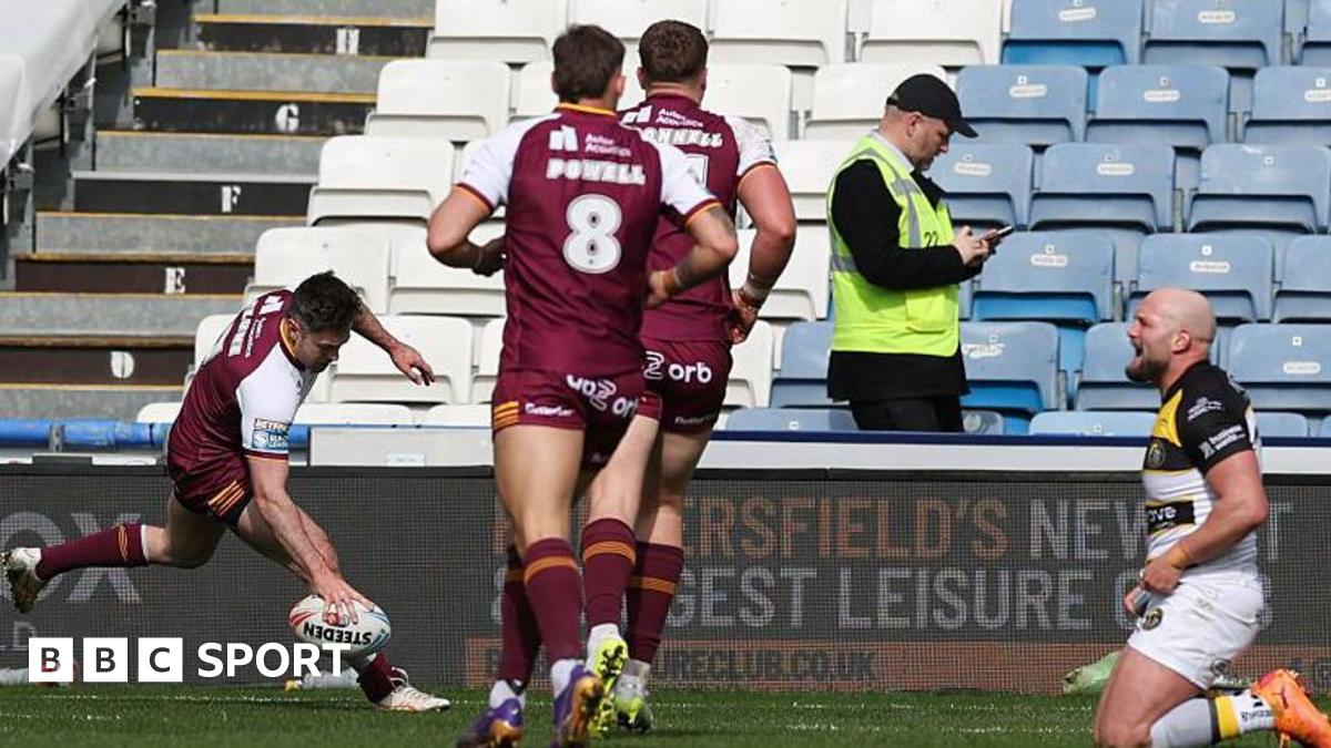 Adam Clune of Huddersfield scores a try