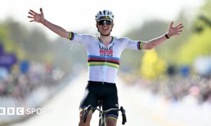 Tadej Pogacar holds his hands out wide as he celebrates winning the 2026 Tour of Flanders