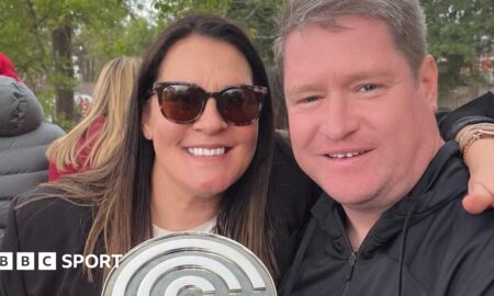 Liverpool Women manager Matt Beard and his wife Debbie smile while celebrating the Reds' Championship title win