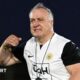Dick Advocaat, wearing a white and black Curacao training top, gestures with his right arm