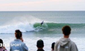 Fans watch surfers at Raglan in New Zealand