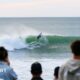 Fans watch surfers at Raglan in New Zealand