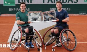 Gordon Reid of Great Britain and Alfie Hewett of Great Britain pose for a photo with their Men's Wheelchair Doubles Trophies