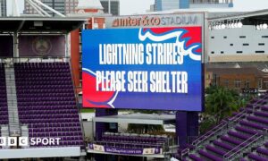 Big screen saying 'lightning strikes please seek shelter'