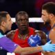 Aziz Abdul reacts after being disqualified for a headbutt during fight against England's Damar Thomas
