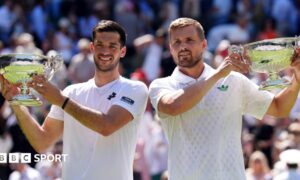 Julian Cash (left) and Lloyd Glasspool pose with their Wimbledon doubles trophies