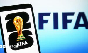 In this illustration, a World Cup 2026 logo is shown on a smartphone screen in front of a Fifa logo