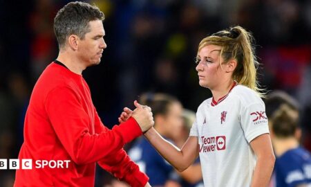 Marc Skinner shaking hands with Ella Toone
