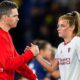Marc Skinner shaking hands with Ella Toone