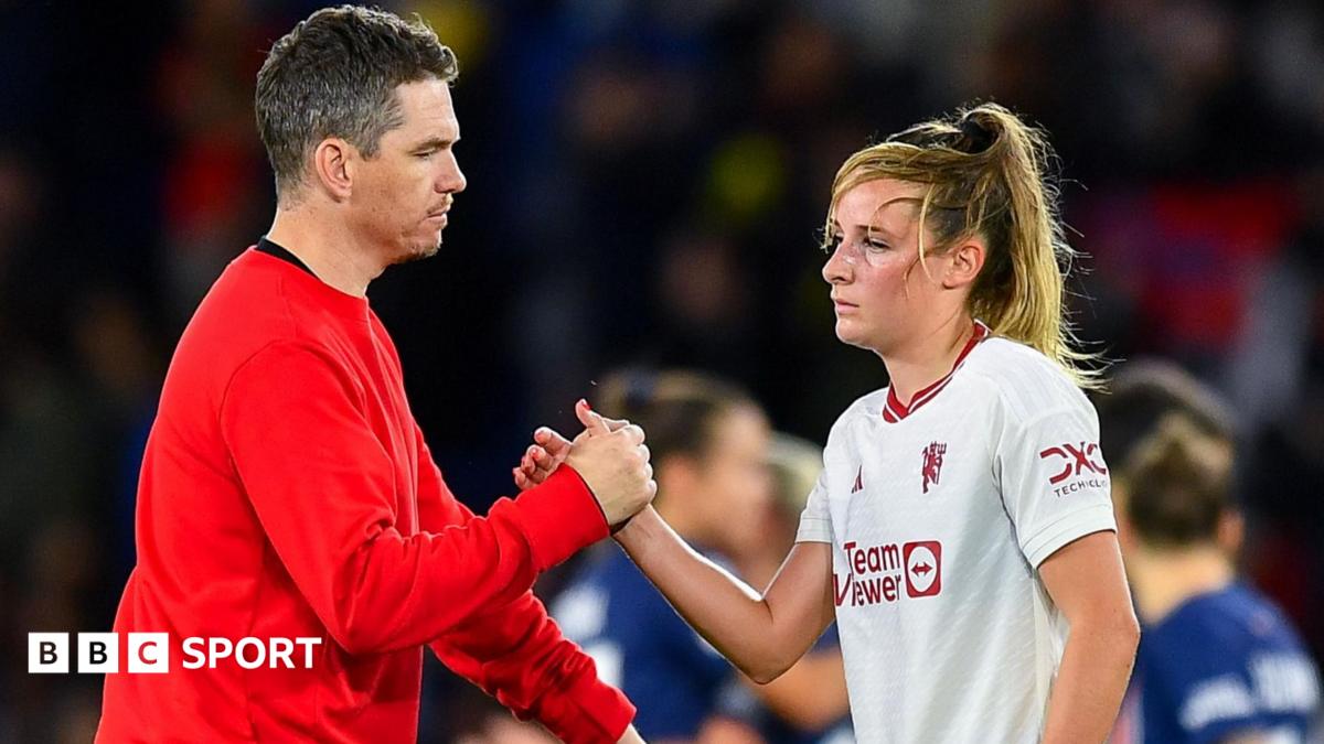 Marc Skinner shaking hands with Ella Toone