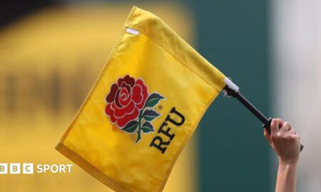 An official holds up a flag with the RFU logo on during the Women's Six Nations match between England and Ireland in Leicester in April 2022