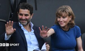 Former Newcastle United shareholders Mehrdad Ghodoussi (L) and Amanda Staveley wave from the directors' box