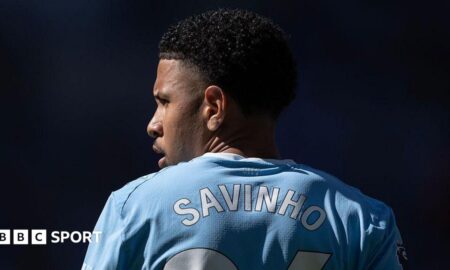 The back of Savino's shirt with his head turned to the side