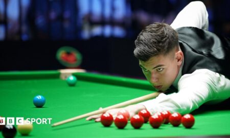 Liam Davies, wearing a white shirt and black waistcoat, leans over the table to play a shot at the Wuhan Open in August