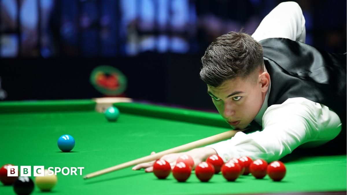 Liam Davies, wearing a white shirt and black waistcoat, leans over the table to play a shot at the Wuhan Open in August