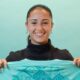 A smiling Jana Fernandez holds a London City shirt